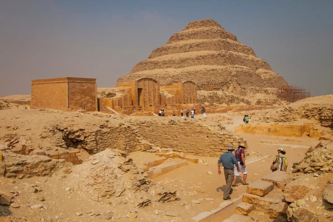 Visitors walking toward the Step Pyramid of Djoser at Saqqara