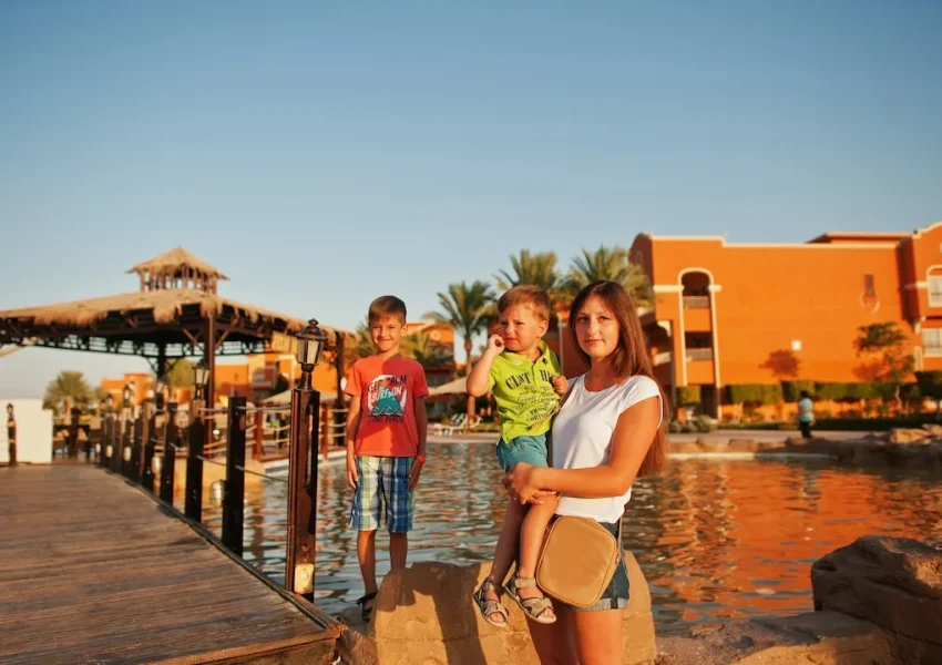 Family vacation sunset by resort lake.